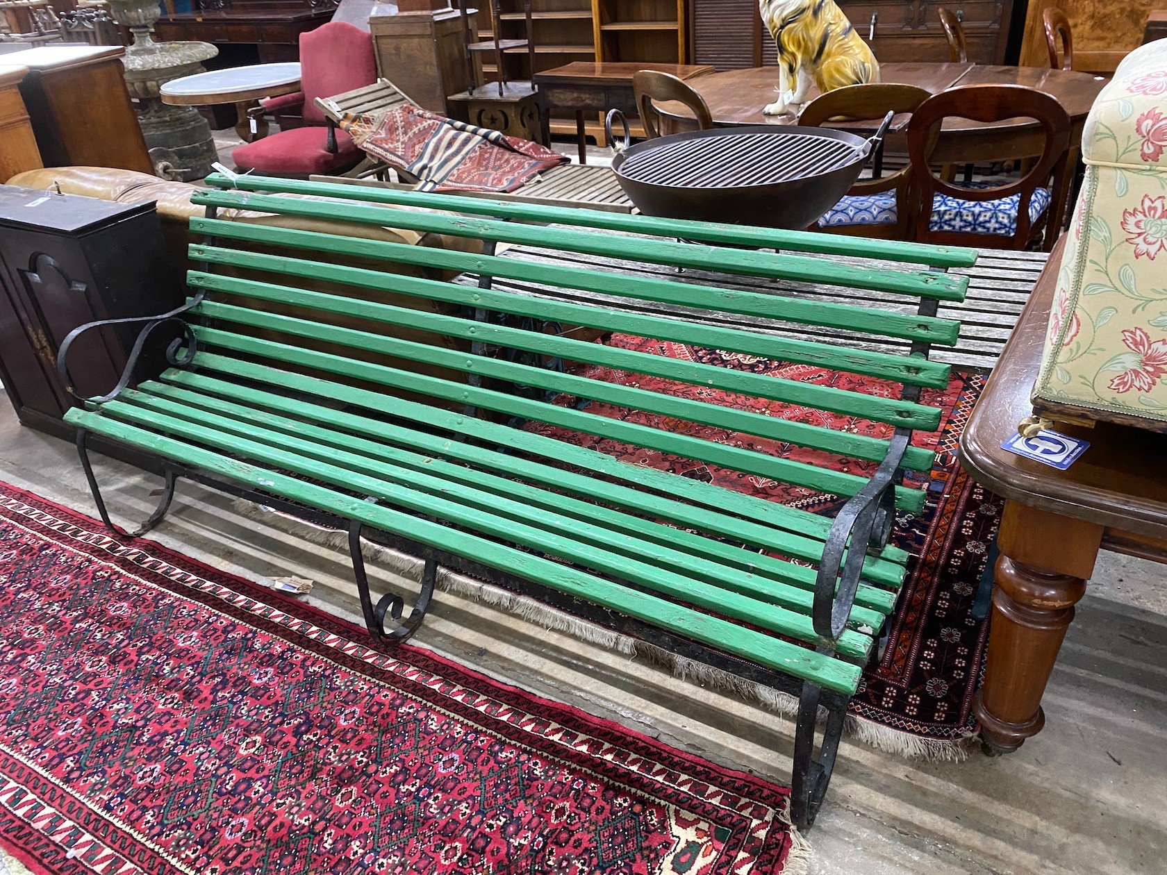 A wrought iron painted slatted wood garden bench, length 213cm, width 70cm, height 86cm